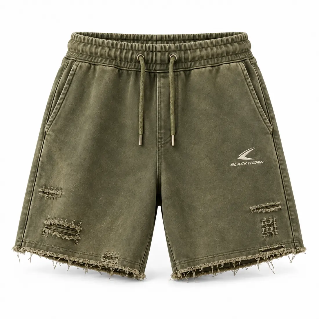 Faded olive distressed sweat shorts with raw frayed hem and stitched repair patches, front