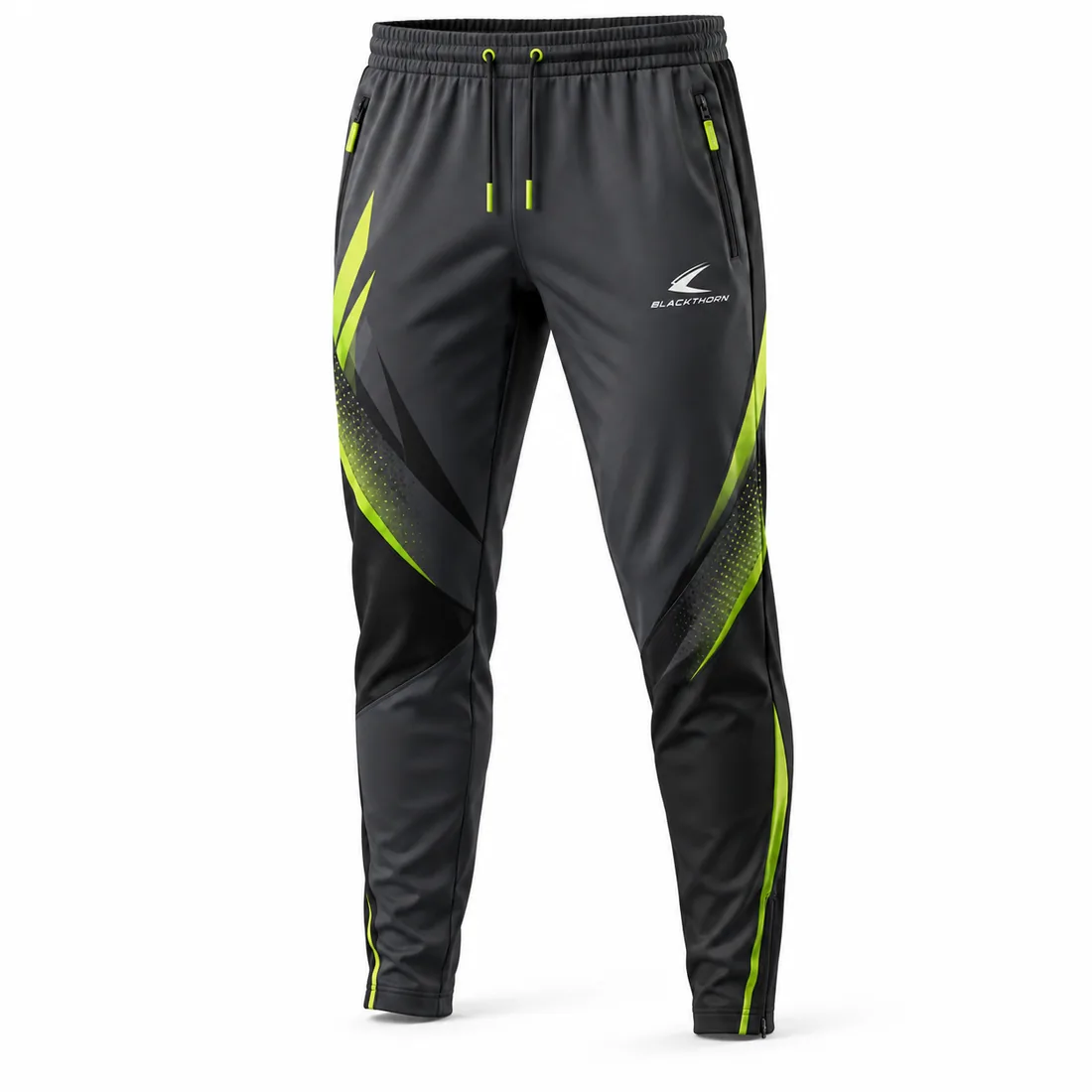 Charcoal and black youth training pants with neon-lime slashes, halftone dots and zip pockets, front view