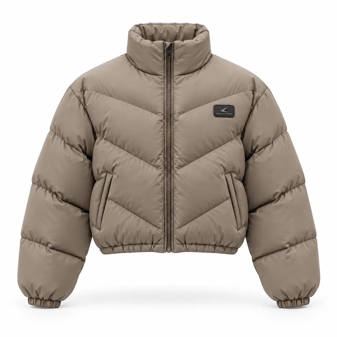 Taupe cropped puffer jacket with chevron quilting and tonal TPR chest badge, front view